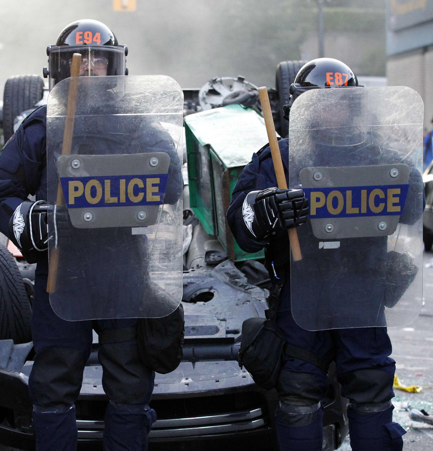 vancouver riot cops and hockey gloves Vancouver riot police after Game 7